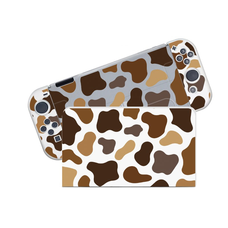 Introducing the Moka Cow Case for Nintendo Switch by petimint: a semi-clear handheld gaming console case with a charming cow-print design featuring an array of brown, tan, and white spots. Perfect for the cozygamer, this stylish accessory beautifully showcases the patterned surfaces from both the front and back views.