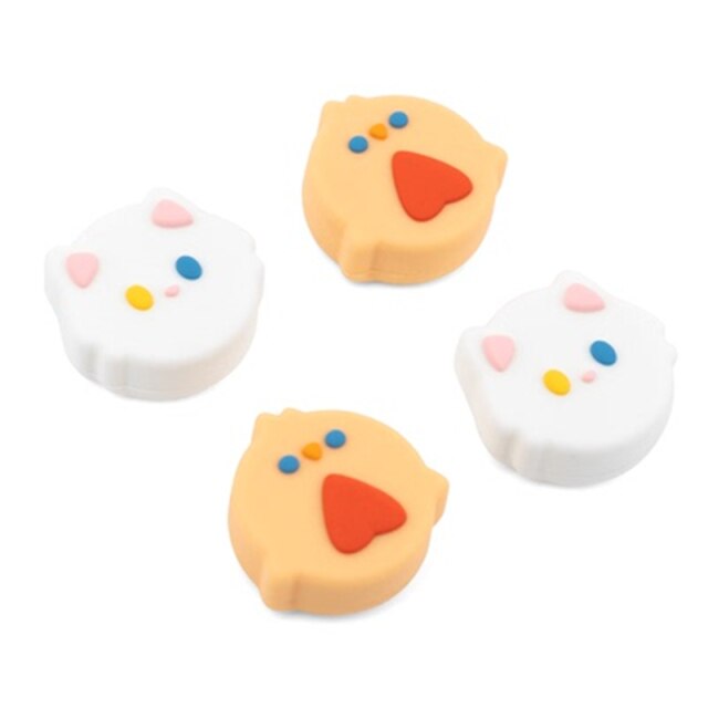 Arrange the **Chicken Thumb Grips for Nintendo Switch** from **petimint** in pairs to add some cozygamer charm to your gaming setup. Two grips resemble white cats with pink ears and multicolored dots for eyes and noses, while the other two resemble yellow chicks with red beaks and blue eyes. The background is plain white.