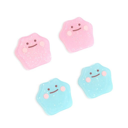 Introducing the Glitter Ditto Thumb Grips for Nintendo Switch by petimint: a set of four, small gel packs styled as adorable cartoon clouds in pink and blue, each with smiling faces and blushing cheeks. On a white background, the pink cloud grips are positioned at the top left while the blue ones rest at the bottom right.