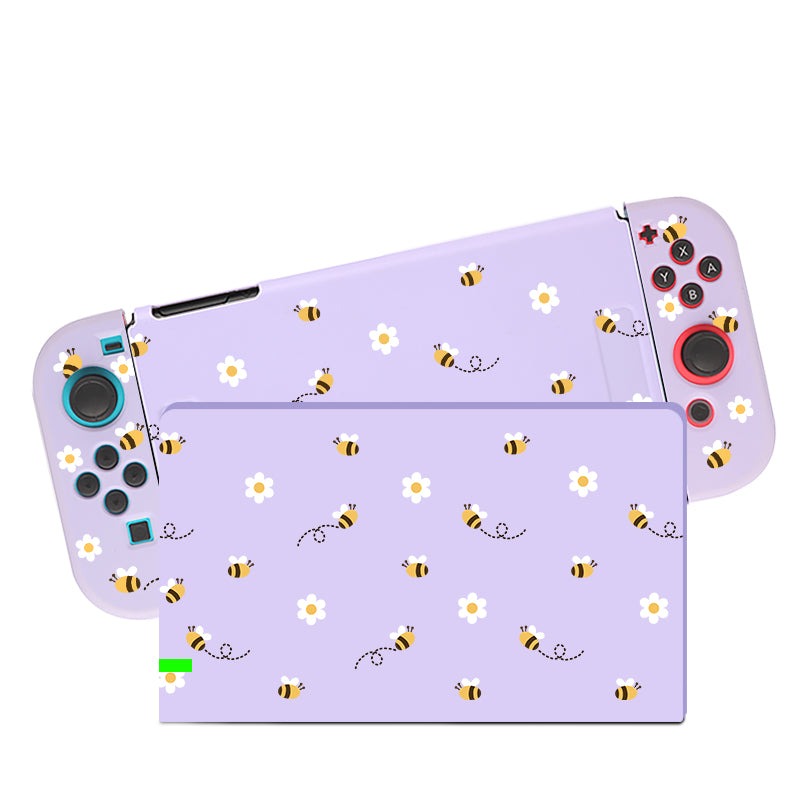 The petimint Little Bee Case for Nintendo Switch, featuring detachable controllers, is showcased. The main console and controllers are adorned with a light purple design that highlights a charming pattern of bees and white daisies, ideal for the cozygamer.