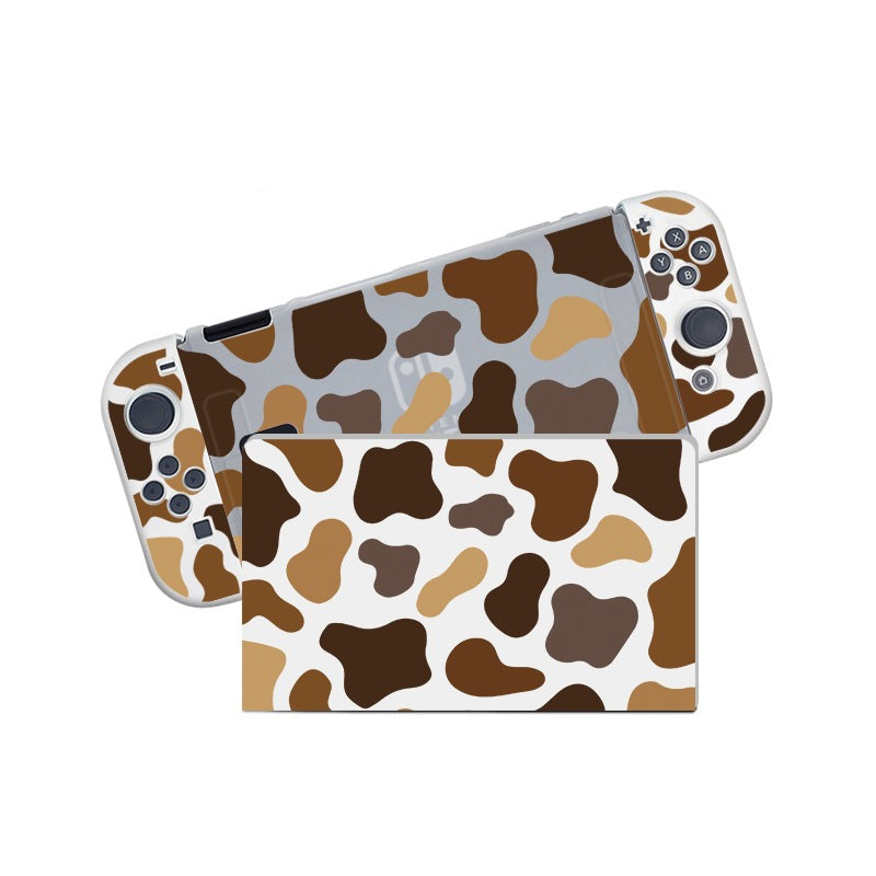 Introducing the Moka Cow Case for Nintendo Switch by petimint—a semi-clear handheld gaming console cover and dock case adorned with a charming cow print pattern in various shades of brown and beige. The design features irregular, cow-like spots scattered across the surfaces, making it perfect for the cozy gamer looking to add a unique touch to their Nintendo Switch setup.