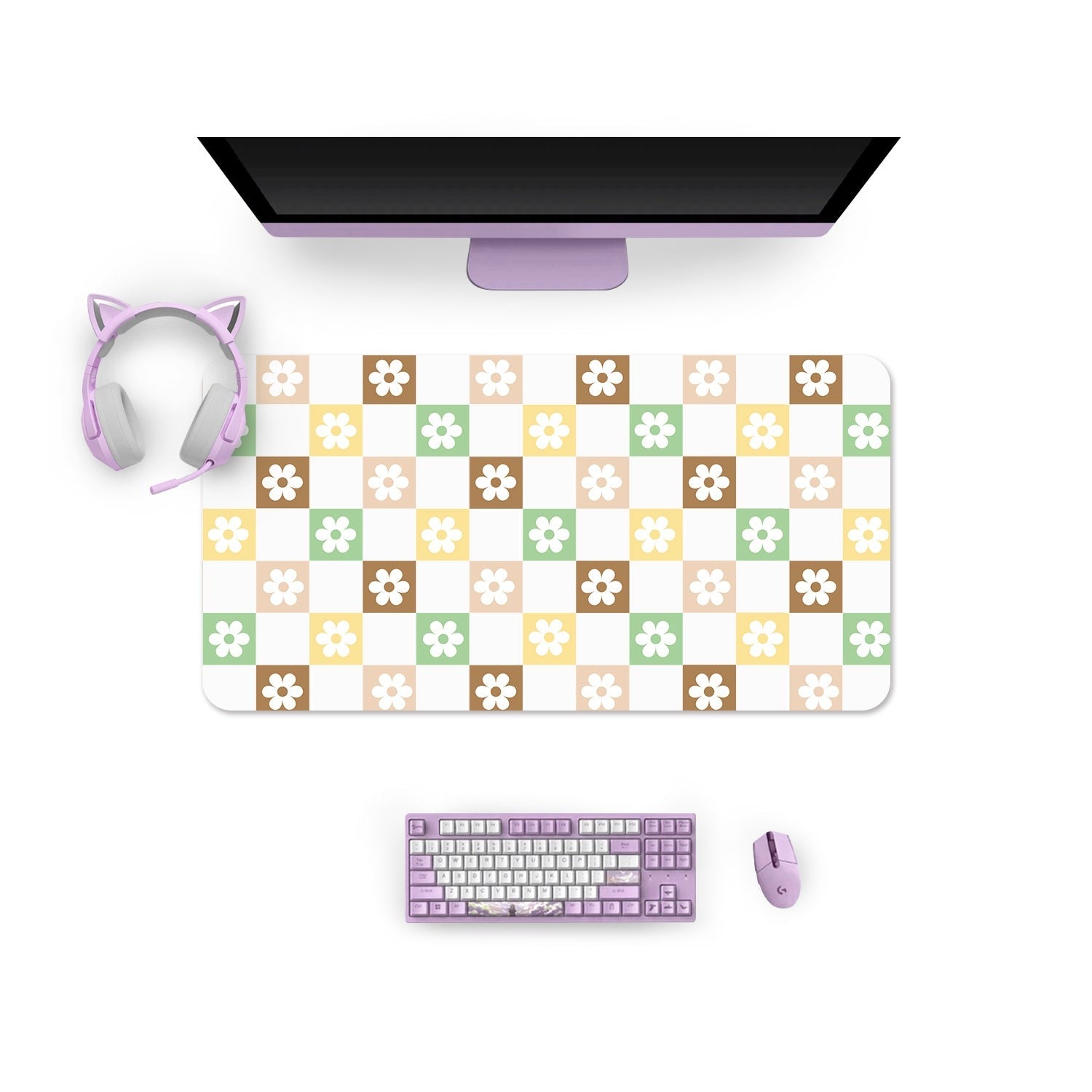 A neatly arranged computer workspace with a monitor, headphones featuring cat ears, a lavender keyboard, and a mouse. The Checkered Seasonal Flowers Mouse Pad from petimint showcases a checkered pattern with pastel colors and floral designs. The lavender keyboard and mouse perfectly complement the overall cozygamer aesthetic.