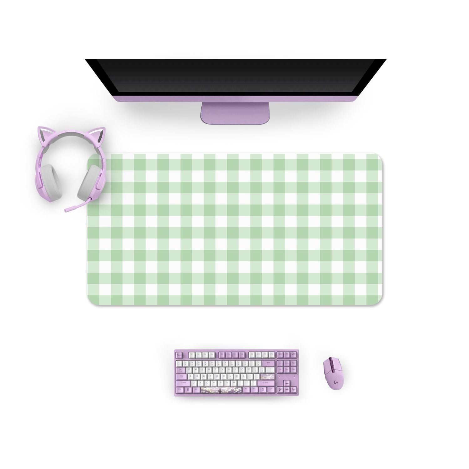 Top-down view of a computer setup featuring a large green and white Picnic Mouse Pad from petimint. Above it is a black monitor. To the left, there are pink cat ear headphones, and at the bottom, there's a purple gaming keyboard with a matching mouse to the right. Perfect for any gamer!