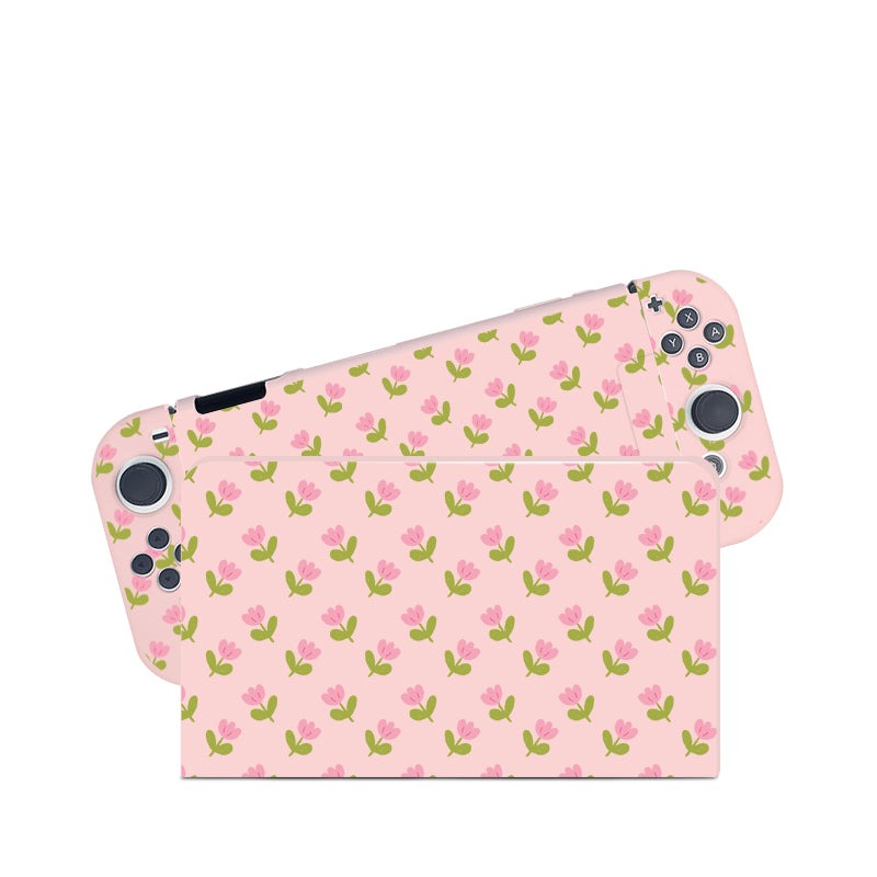 A cozygamer's dream, the Pink Tulips Case for Nintendo Switch by petimint transforms your console into a charming accessory with its light pink skin adorned with an adorable pattern of small pink flowers and green stems evenly scattered across the surface. The case ensures visible control buttons and analog sticks on both sides, providing seamless gaming sessions.