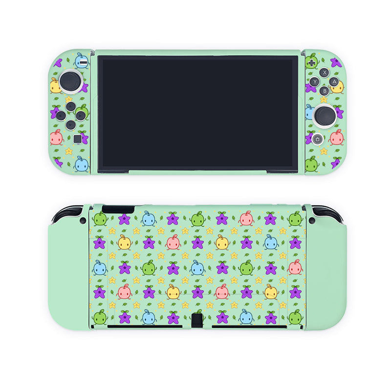 A handheld Nintendo Switch gaming console encased in a mint green Junimos Case from petimint. The case features a colorful pattern of small, cute creatures, including stars, fish, and animals on both the front and back. The screen is turned off, with various buttons visible on the controllers. Perfect for any gamer!