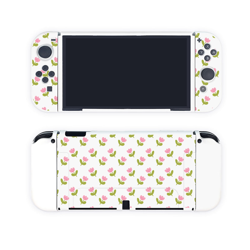 A handheld gaming console is shown from the front and back. This cozygamer's dream, the Pink Tulips Case for Nintendo Switch by petimint, features a white case adorned with a pattern of small pink flowers and green leaves. The screen is black with buttons and thumbsticks clearly visible, making it the perfect accessory for your gaming apparel collection.