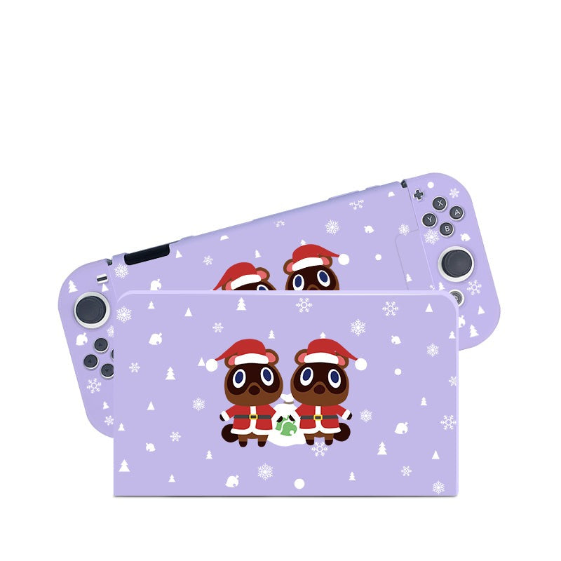 The Timmy & Tommy Christmas Case for Nintendo Switch by petimint is a light purple handheld gaming console cover, adorned with two cartoon raccoons in red Santa hats and scarves. Scattered snowflakes and small evergreen trees enhance its winter holiday theme, making it the perfect accessory for any gamer this season.