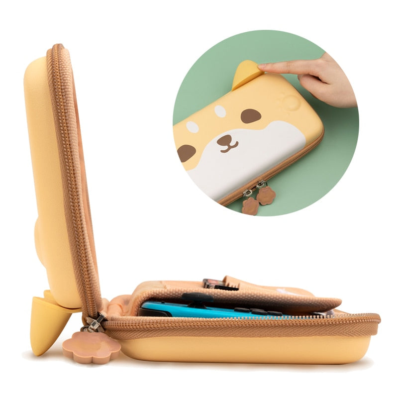 Introducing the Shiba Pouch for Nintendo Switch by petimint, a light brown zippered case adorned with an adorable animal face and ears. This partially open pouch is ideal for storing your gaming essentials or Nintendo Switch, and features a close-up circular highlight to emphasize the ear detail on the case.